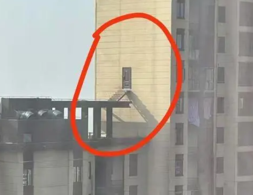 28樓業(yè)主破墻開(kāi)門(mén) 搭梯通往隔壁樓頂 這也太危險(xiǎn)了